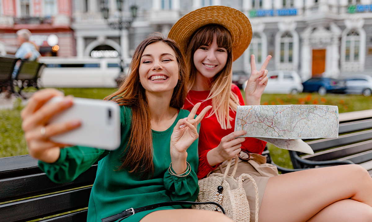 1200stylish-young-women-traveling-together-dressed-spring-trendy-dresses-accessories-having-fun-taking-photo-phone-camera-holding-map.jpg